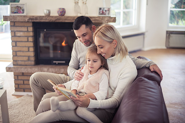 Family sitting in front of a Propane Fireplace